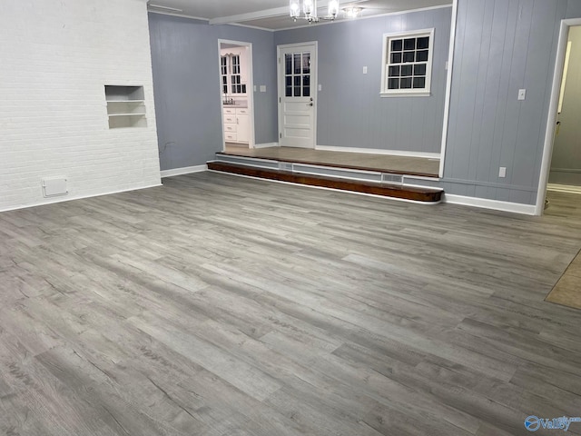 unfurnished room featuring wood-type flooring and ornamental molding