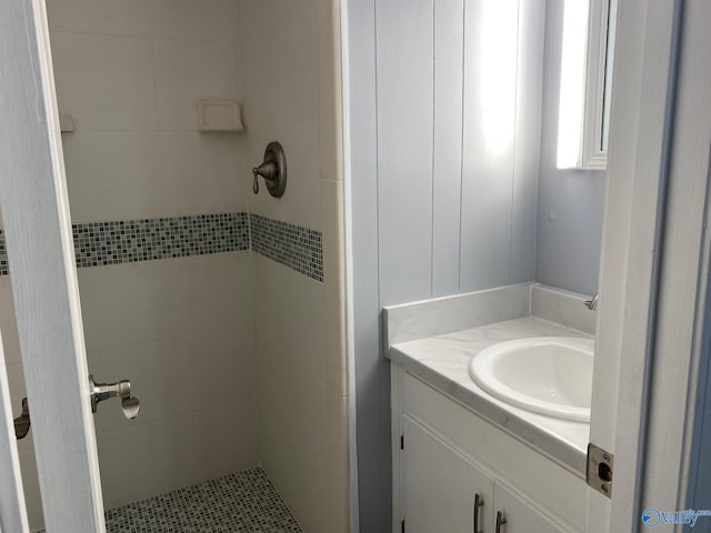 bathroom featuring vanity and tiled shower