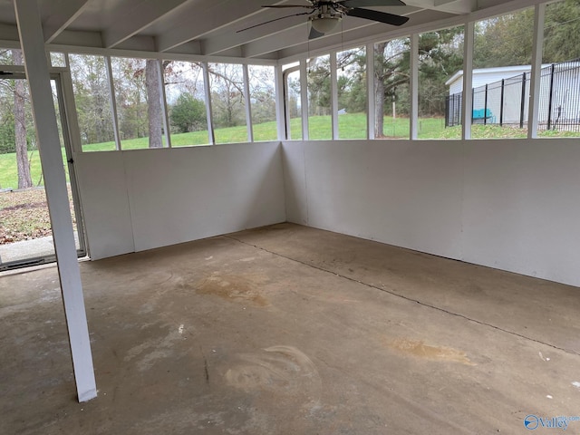 unfurnished sunroom featuring ceiling fan