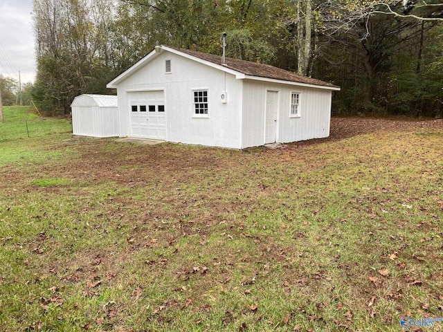garage featuring a lawn