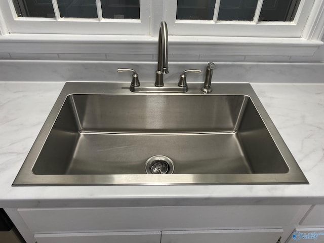 details with white cabinets and sink