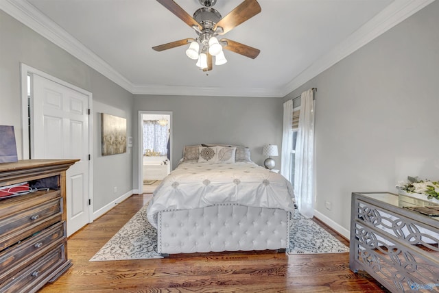 bedroom with crown molding, connected bathroom, hardwood / wood-style floors, and ceiling fan