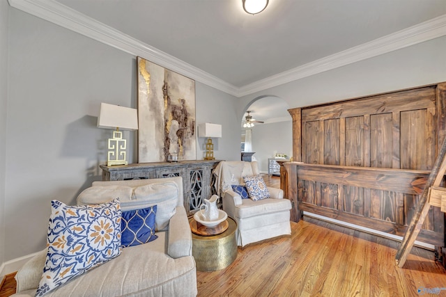 living area with ornamental molding and light hardwood / wood-style flooring