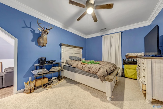 carpeted bedroom with crown molding and ceiling fan