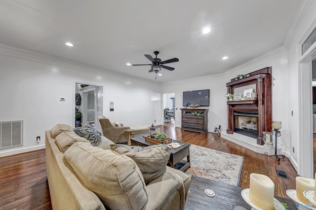 living room with crown molding, dark hardwood / wood-style floors, and ceiling fan