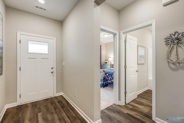 entryway featuring visible vents, dark wood finished floors, and baseboards