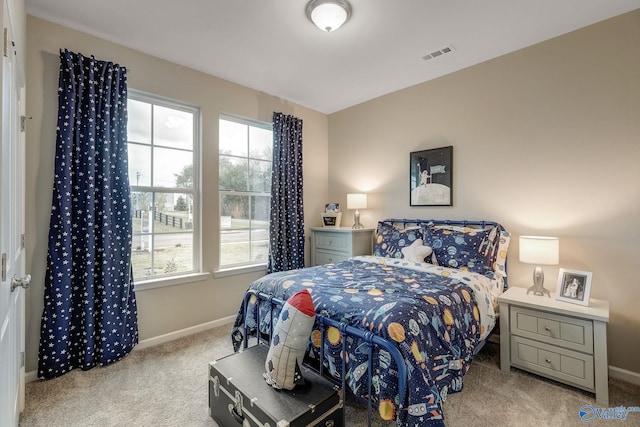 carpeted bedroom featuring baseboards and visible vents