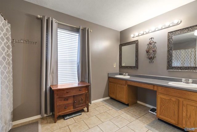 bathroom with vanity, tile patterned floors, and a textured ceiling