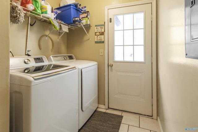 laundry room with light tile patterned floors and washing machine and clothes dryer