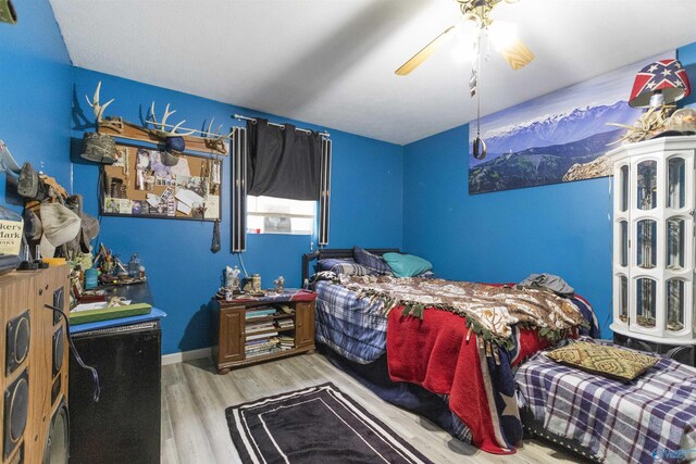 bedroom featuring ceiling fan and light hardwood / wood-style floors