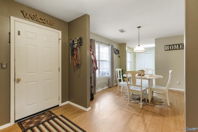 entryway with hardwood / wood-style flooring