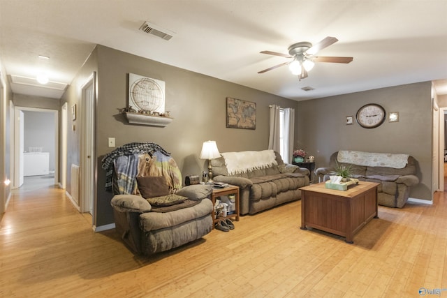 living room with ceiling fan and light wood-type flooring