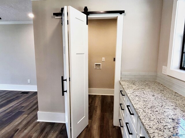 bathroom featuring vanity, ornamental molding, baseboards, and wood finished floors