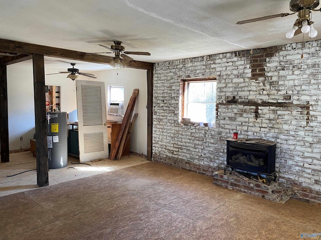 unfurnished living room with water heater, a ceiling fan, a wood stove, a textured ceiling, and brick wall