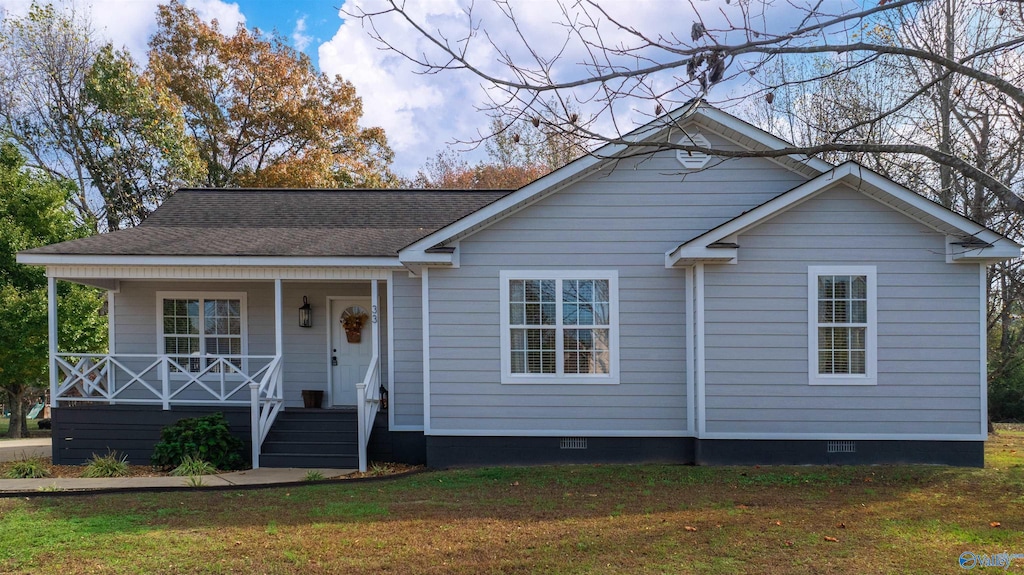 view of front of home with covered porch and a front yard