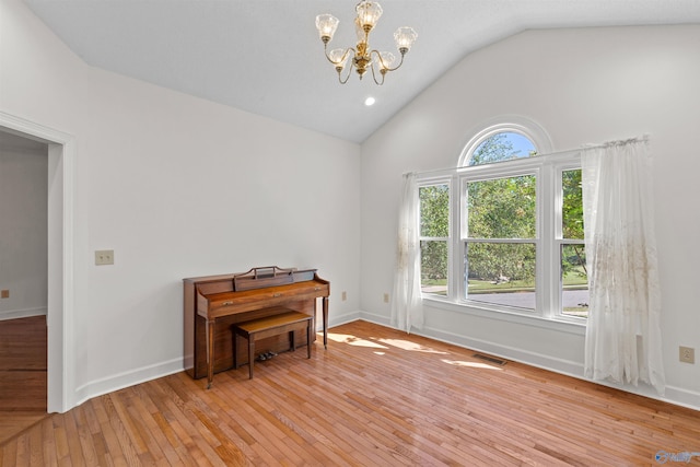 misc room featuring light wood-type flooring, plenty of natural light, and lofted ceiling