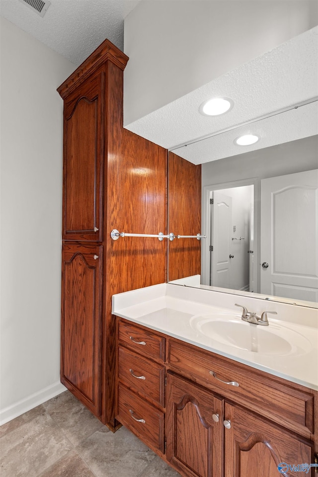 bathroom with vanity and a textured ceiling