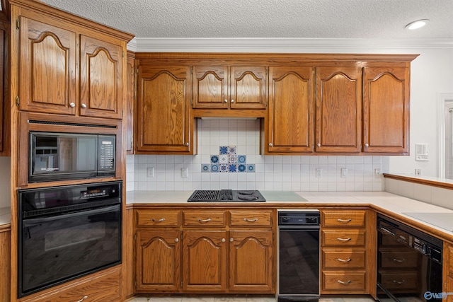 kitchen featuring a textured ceiling, black appliances, backsplash, and ornamental molding