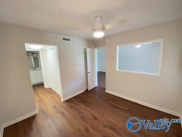 spare room with hardwood / wood-style floors and ceiling fan