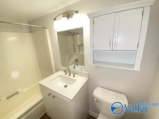 full bathroom with shower / bathtub combination, vanity, and toilet