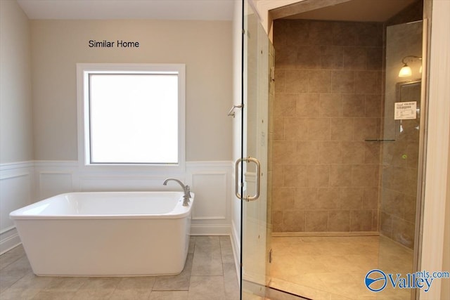 CAMBRIDGEE2 Mallard Dr, Madison, AL 35756 - bathroom featuring a freestanding bath, a shower stall, a wainscoted wall, tile patterned floors, and a decorative wall