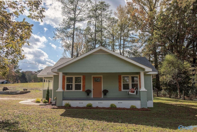 bungalow-style house featuring a porch and a front yard