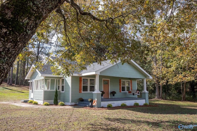 view of front of house with a porch and a front yard