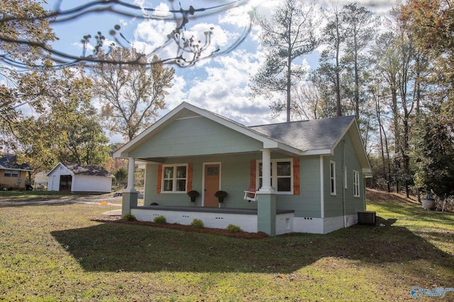 bungalow-style house featuring covered porch and a front lawn