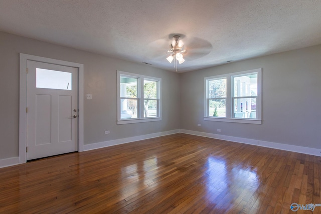 entrance foyer featuring ceiling fan, a textured ceiling, and hardwood / wood-style flooring