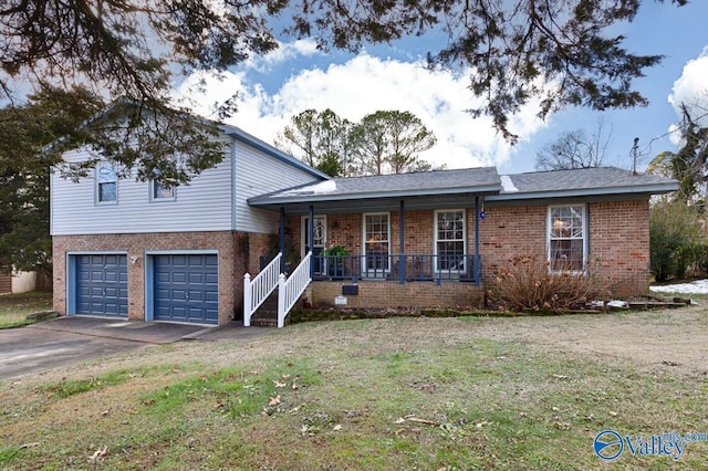 view of front of house featuring covered porch, a front lawn, and a garage