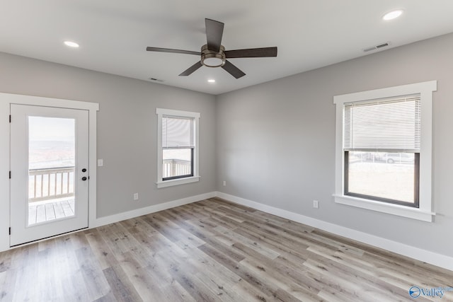 unfurnished room featuring light hardwood / wood-style floors and ceiling fan