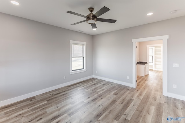 unfurnished room with ceiling fan and light hardwood / wood-style flooring