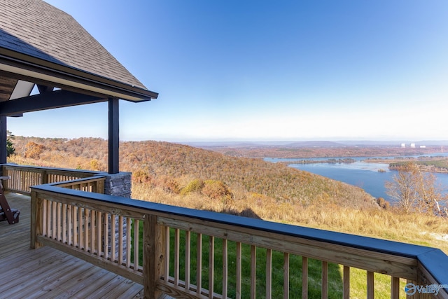 wooden terrace featuring a water view