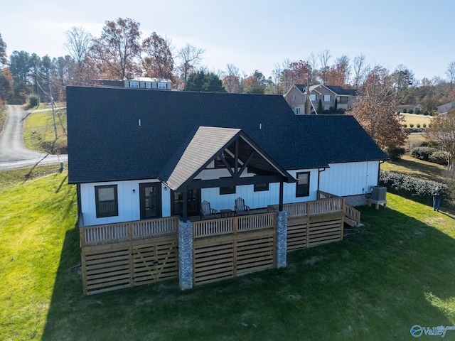 back of house with a lawn, central AC unit, and a deck