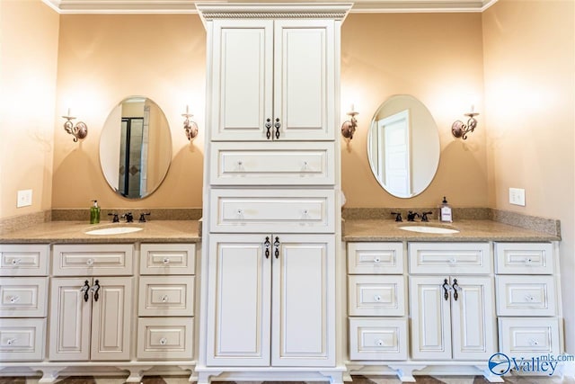 bathroom with vanity and ornamental molding