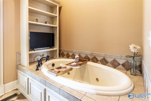 bathroom with built in shelves and a bathtub