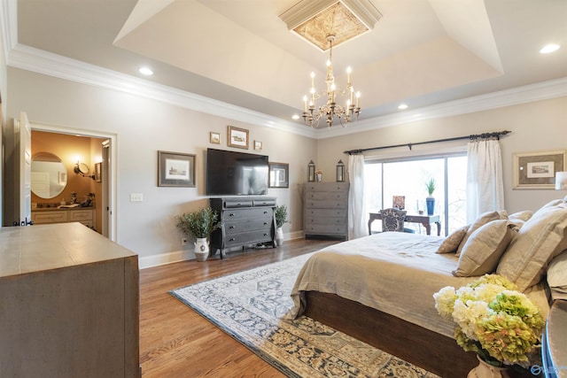 bedroom featuring hardwood / wood-style floors, a notable chandelier, a raised ceiling, and crown molding