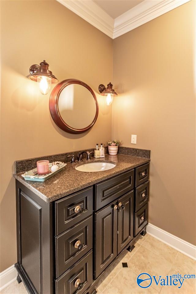 bathroom with vanity, tile patterned floors, and ornamental molding