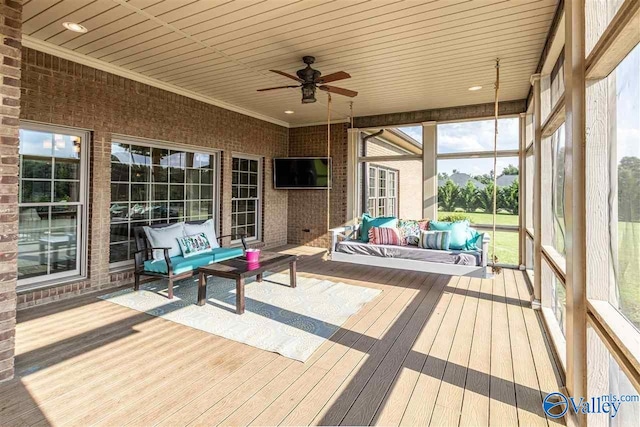 unfurnished sunroom featuring ceiling fan and wood ceiling