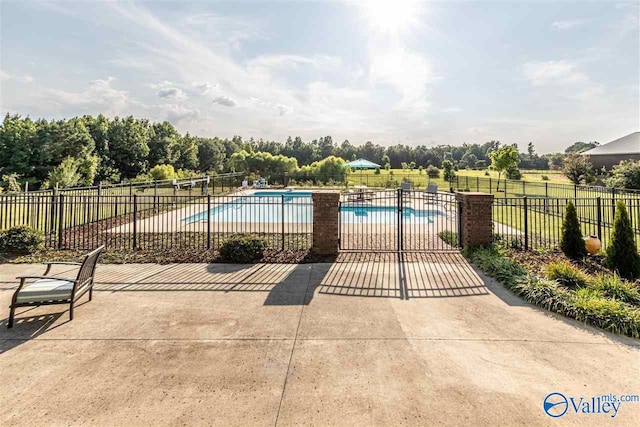 pool featuring a patio area and fence