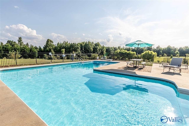 view of swimming pool with a patio area, fence, and a fenced in pool