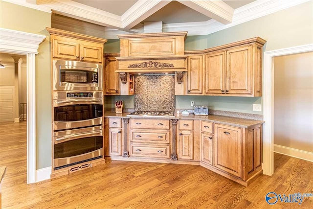 kitchen with stainless steel appliances, light countertops, ornamental molding, and light wood finished floors