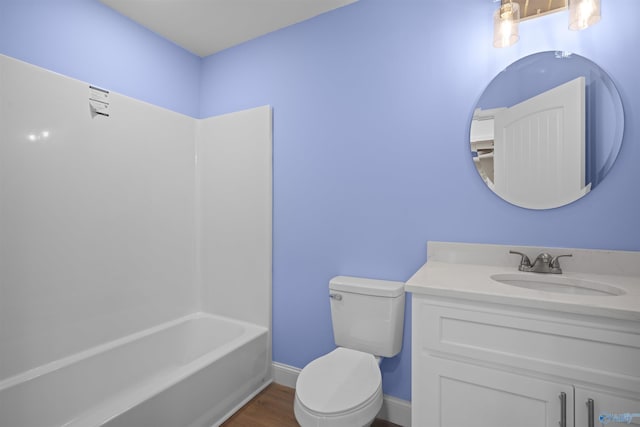 full bathroom with toilet, vanity, wood finished floors, and baseboards