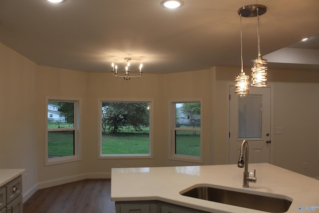 kitchen featuring a chandelier, decorative light fixtures, a sink, and light countertops