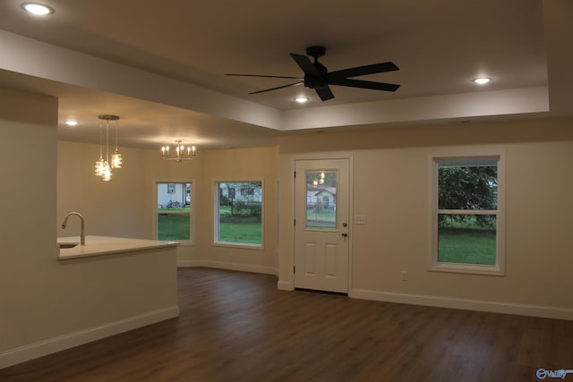 entrance foyer featuring a tray ceiling, baseboards, recessed lighting, and dark wood-style floors
