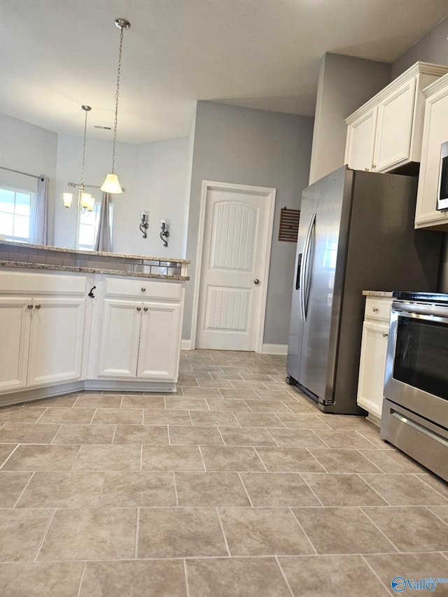 kitchen featuring a chandelier, white cabinetry, stainless steel stove, and hanging light fixtures