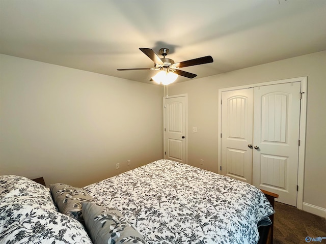 carpeted bedroom featuring a closet and ceiling fan