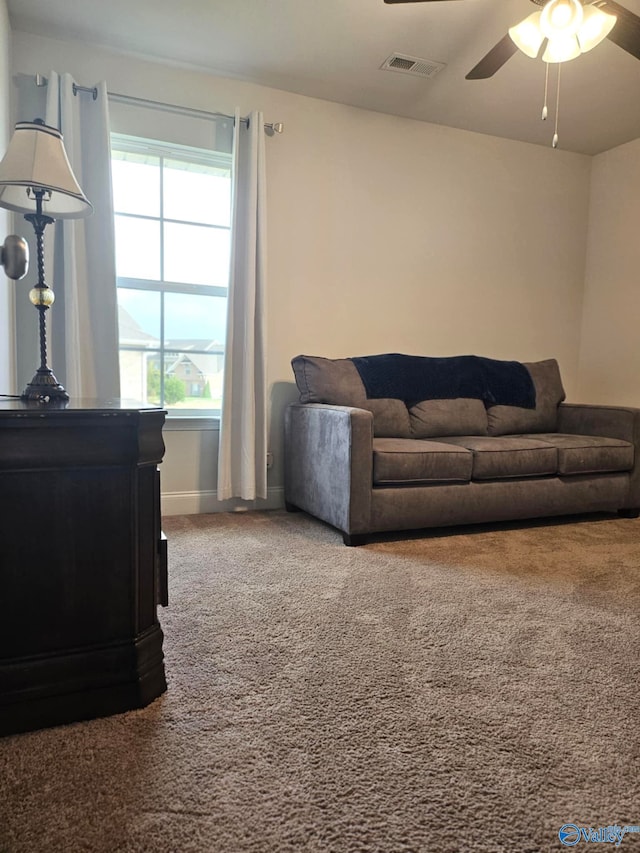 living room featuring carpet flooring and ceiling fan