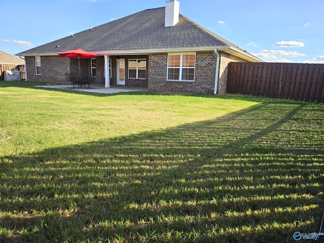 back of house featuring a yard and a patio