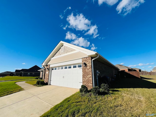 view of home's exterior featuring a garage and a yard